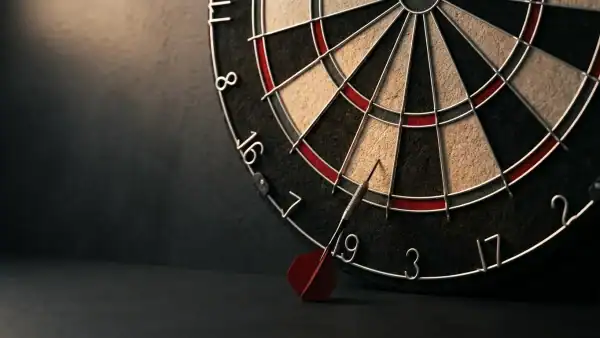 A dart fallen below a bristle dartboard after bouncing out from the wire