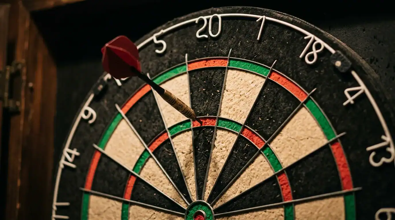 Close-up of a dartboard with a dart in the treble 20 segment used in cricket darts