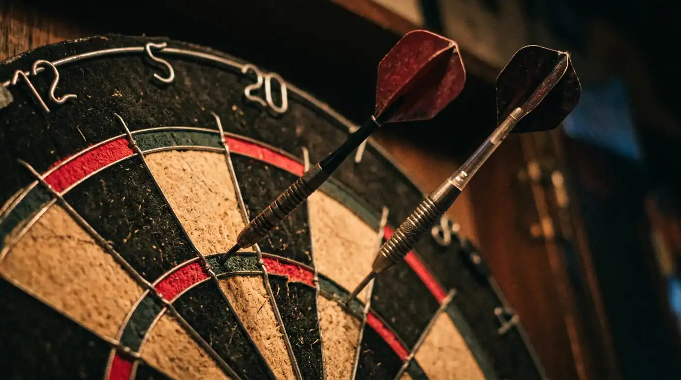 Two darts embedded in a dartboard at different angles showing inconsistent flight