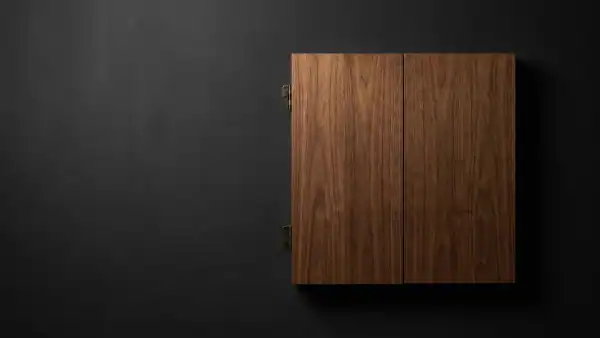 Best dartboard cabinet – closed wooden cabinet on dark charcoal surface