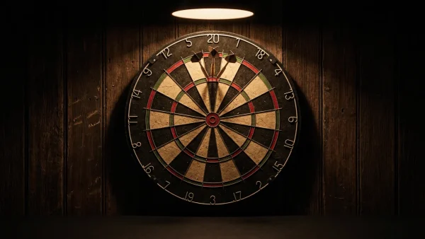Dartboard under warm pendant light with three darts in treble 20 representing PDC World Championship history